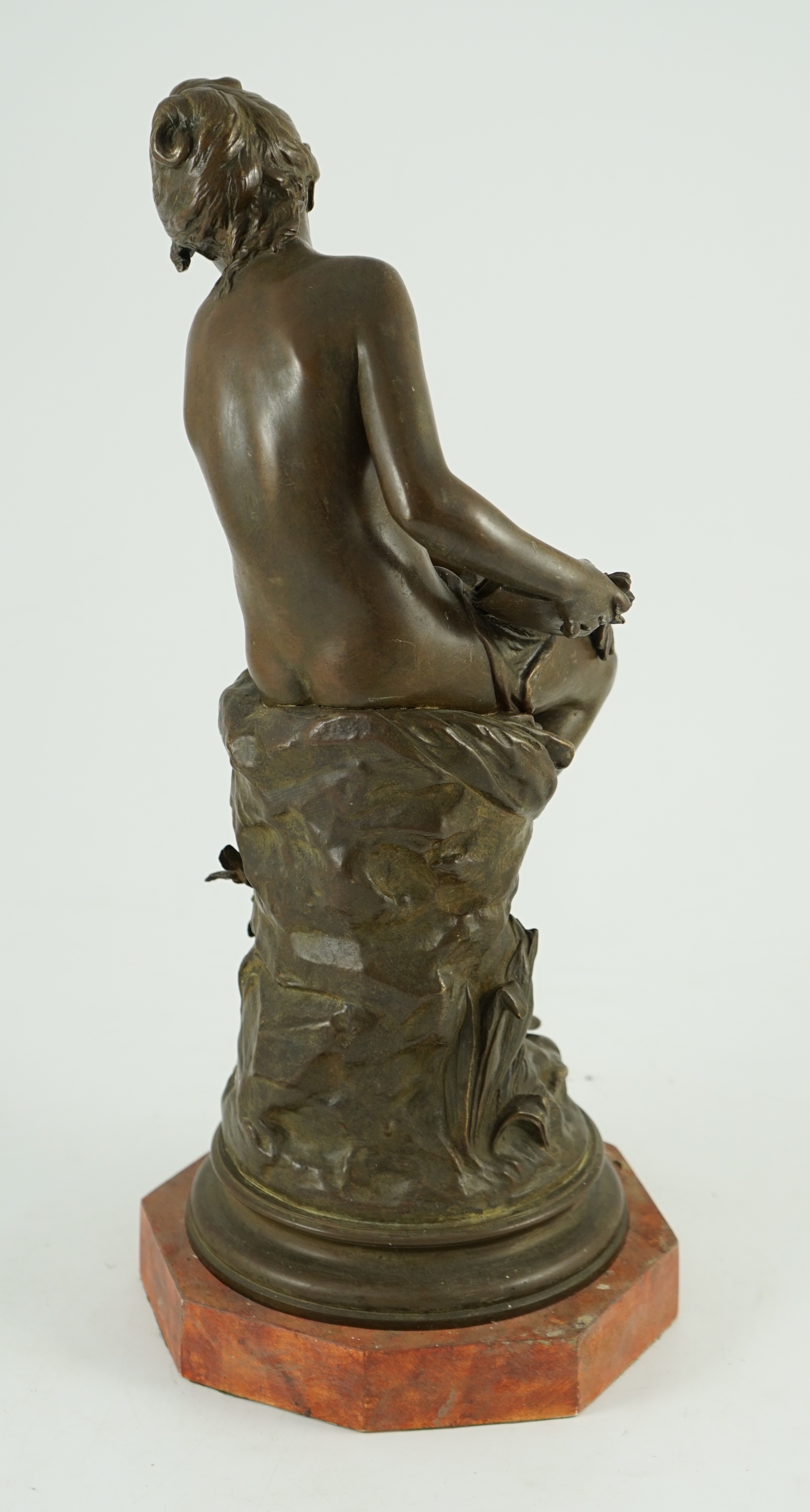 Auguste Moreau (French, 1834-1917). A bronze figure of a nude girl seated on a mound holding a book with birds at her feet, overall height 45cm